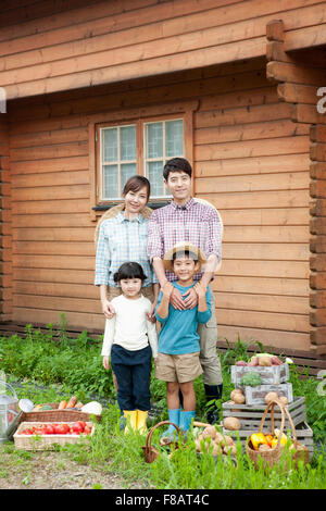 Happy family standing in front of cherry blossom tree Stock Photo - Alamy