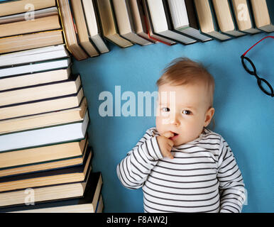 One year old baby with spectackles and books Stock Photo