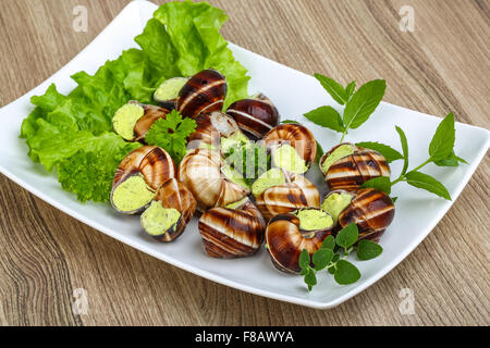 Escargot with parsley butter with salat leaves and mint Stock Photo