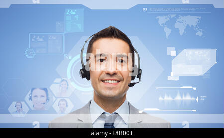 smiling businessman in headset over virtual screen Stock Photo