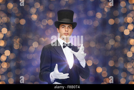 magician in top hat showing trick Stock Photo