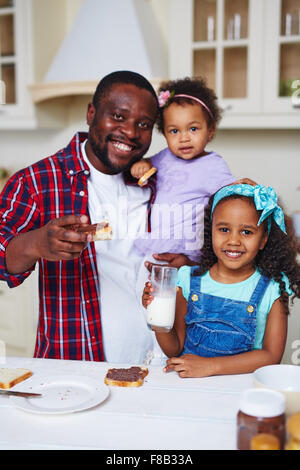 Happy African-American family having sandwiches for brunch Stock Photo