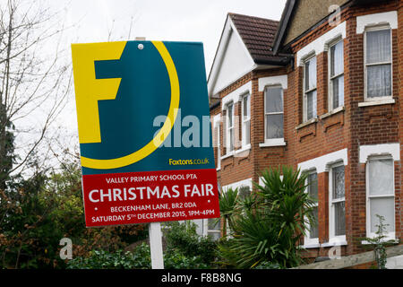 Estate agent's board used to advertise the Valley Primary School Christmas Fair. Stock Photo