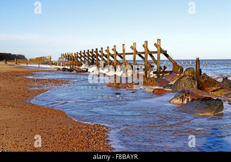 A line of abandoned timber sea defences at Happisburgh, Norfolk, England, United Kingdom. Stock Photo