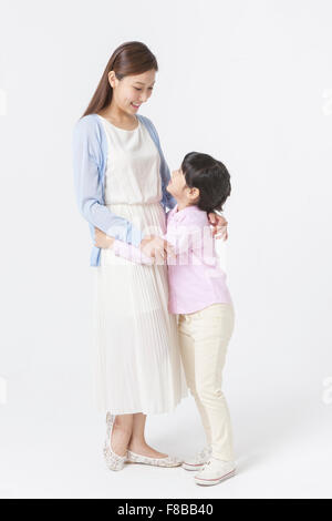 Young Korean mother and daughter holding each other and looking at each other Stock Photo