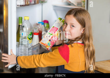 8 year old boy in front of a fridge. Stock Photo