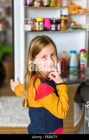 8 year old boy in front of a fridge. Stock Photo