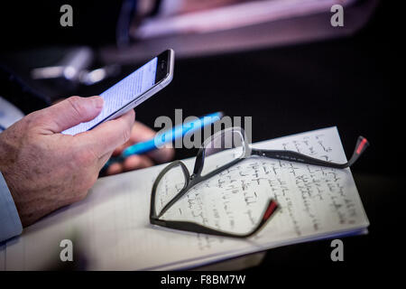 Man using his cell phone during a meeting. Stock Photo