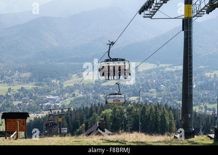 People riding on Butorowy Wierch Chairlift up to Gubałowka Mountain, Zakopane, Tatra County, Poland Stock Photo