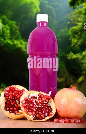 Fresh pomegranate juice with a forest background Stock Photo