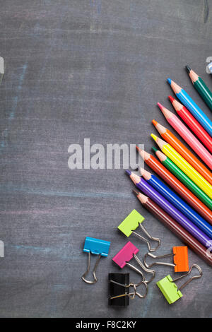 School and office supplies on blackboard background. Top view with copy space Stock Photo