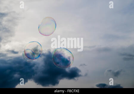 large soap bubbles floating across cloudy sky Stock Photo