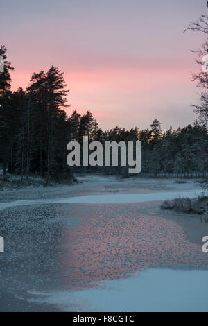 Newly frozen lake at dusk Stock Photo