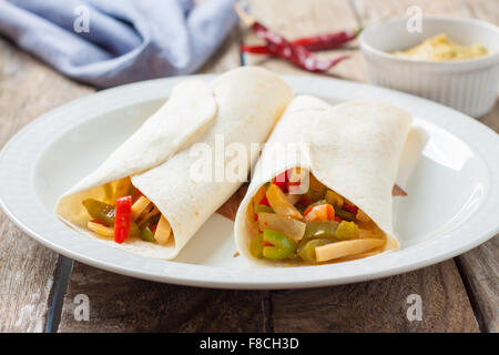 mexican style wrap filled with chicken and vegetables Stock Photo
