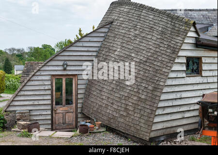 Herefordshire, UK. A self built house, timber clad, with a curved roof covered with wooden cedar shingles Stock Photo