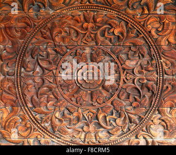 Beautiful floral pattern on the wooden wall is photographed close up Stock Photo