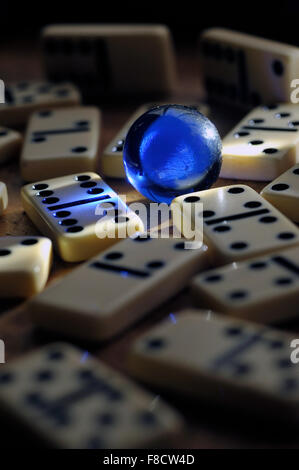 blue glass marble with dominoes Stock Photo