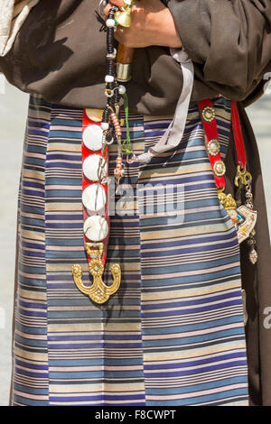 Tibetan fabrics and accessories on a Tibetan woman in Lhasa Stock Photo