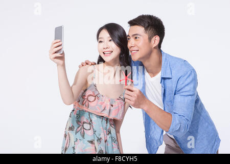 Couple in casual wear taking a self photo together with a starfish in man's hand Stock Photo