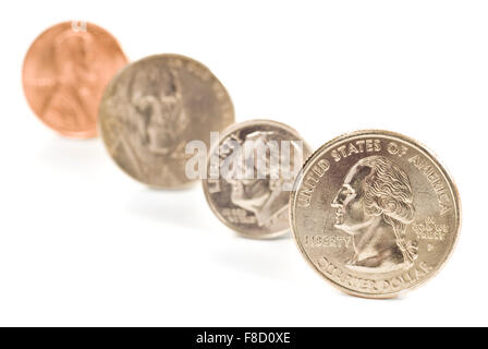 A penny, nickel, dime, and quarter standing on end in a diagonal line with a white background. Stock Photo