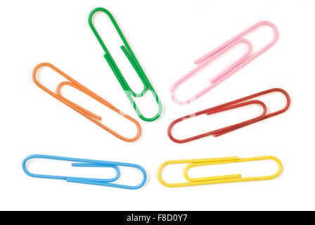 Six different color paper clips laid out on a white background. Stock Photo