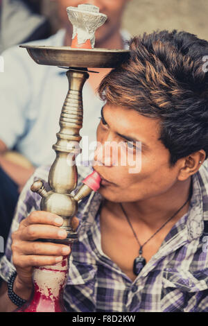 Nepalese young man smoking the Shisha Stock Photo