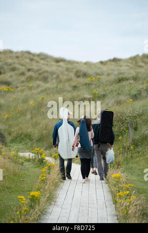 Young classical musicians: The Solem String Quartet walking away along a wooden track at Aberystwyth Music Fest 2015 Stock Photo