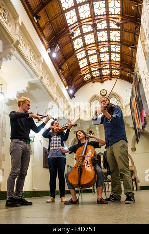 Young classical musicians: The Solem String Quartet playing in the ornate Quadrangle of Aberystwyth University 'old college' at Aberystwyth Music Fest , summer 2015 Stock Photo