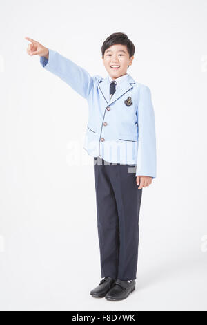 Boy of school age pointing with finger upwards Stock Photo - Alamy