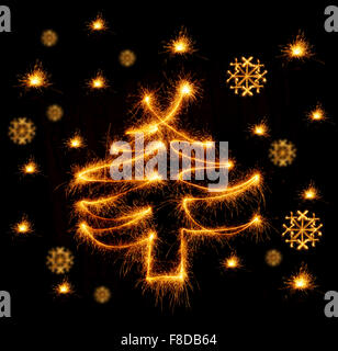 Christmas tree with snowflakes made by sparkler on a black background Stock Photo