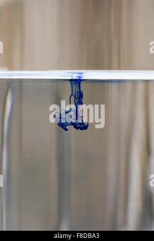 Drop of blue dye diffusing through water. Number two of four in diffusion series. Stock Photo