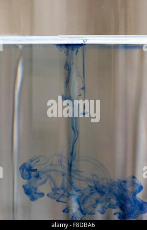 Drop of blue dye diffusing through water. Number four of four in diffusion series. Stock Photo