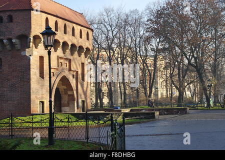 Krakow, Planty park. On the left fragment of the Barbican, part of the old ramparts. In the background there is Basztowa street. Stock Photo