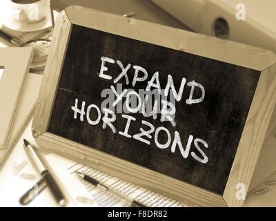 Expand Your Horizons. Motivation Quote a Blackboard. Stock Photo