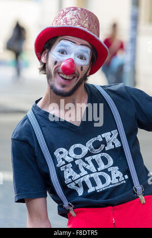 Clown performing in the street to provide info against AIDS Stock Photo