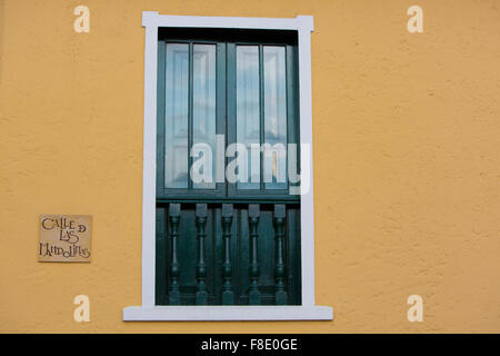 Sign on colonial yellow wall with window details, Bogota Stock Photo