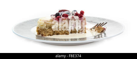 Plate of home made strawberry and fresh berry cheesecake with cream on a white background Stock Photo