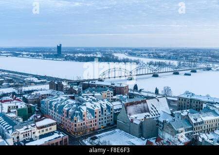 Winter cityscape and railway bridge across Daugava river, Riga, Latvia Stock Photo