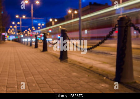 Trail of light left by tram, night city blurred image Stock Photo