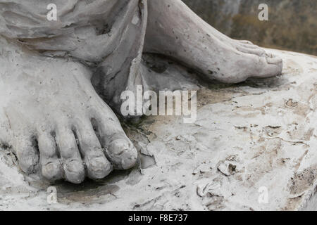 Detail of a marble statue, depicting the foot of the suffering Christ Stock Photo