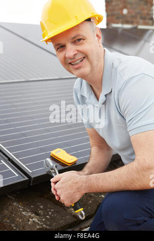 Engineer Installing Solar Panels On Roof Of House Stock Photo