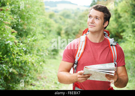 Young Man On Hike Through Countryside Stock Photo