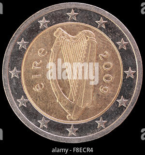 National side of two euro coin issued by Ireland isolated on a black background. The irish obverse face depicts the Celtic harp, Stock Photo