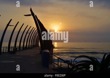 Golden sunrise over the sea with a pier in front,  at Umhlanga,  South Africa Stock Photo