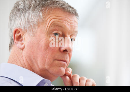 Thoughtful Senior Man At Home Stock Photo