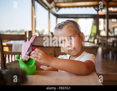 Portrait of a serious child girl. Shallow depth of field. Selective focus on child's face. Stock Photo