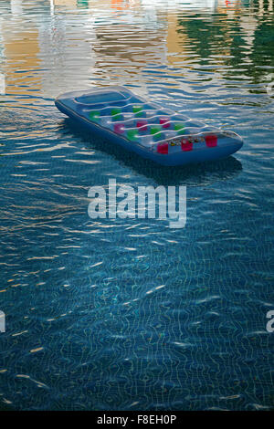 air bed floating  in swimming pool Stock Photo