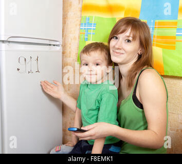 Mom teaches a child to emergency phone numbers Stock Photo