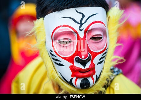 Paris, France - Feb 17, 2013: Chinese performer wearing a monkey mask in traditional costume at the chinese new year parade Stock Photo