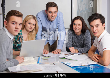 Teacher Working In Classroom With Students Stock Photo